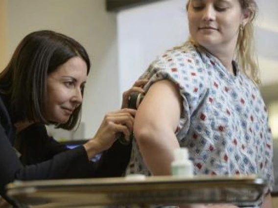 A dermatologist needs to exam your skin up close to make a proper diagnosis. Pictured here: Clara Curiel, MD, co-director of the Skin Cancer Institute.
