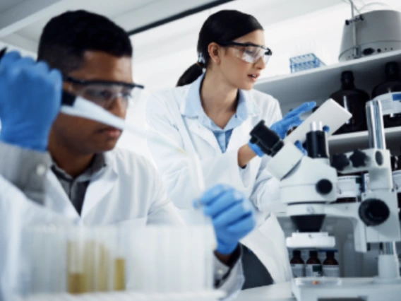 Post-Baccalaureate Students with pipette in lab