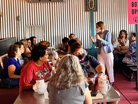 Cancer Center Director Joann Sweasy, PhD, (right) speaks to the public at Rollies Mexican Patio in Tucson at the first of the center’s scientific cafes.