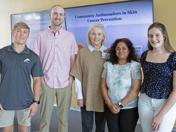 Four people pose for a photo at the sun safety community ambassador training.