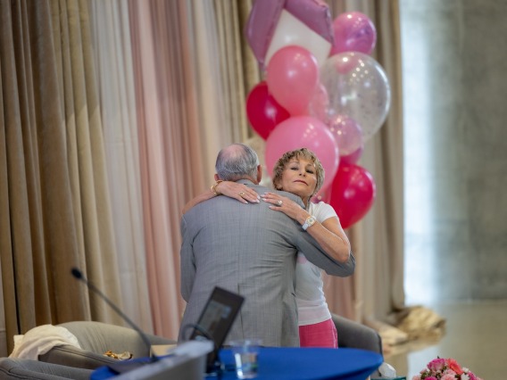 Ginny Clements hugs Robert C. Robbins, MD, president of The University of Arizona.