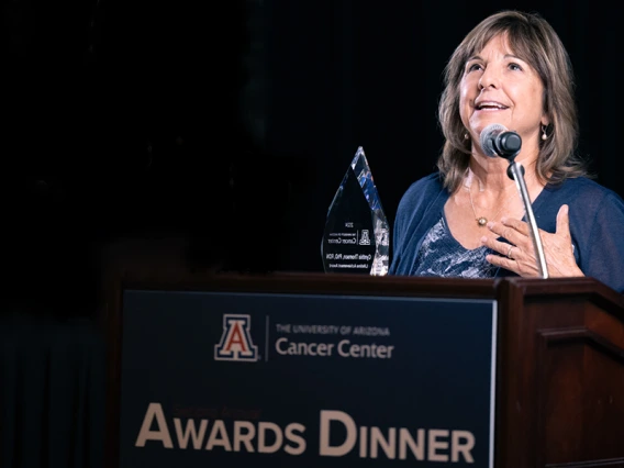 Cynthia Thomson holds her glass Lifetime Achievement Award at this year's UACC Awards Dinner.