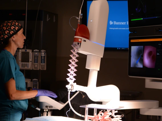 Surgeon Stephanie Worrell operates a robotic machine in a surgery room of Banner Health and the University of Arizona