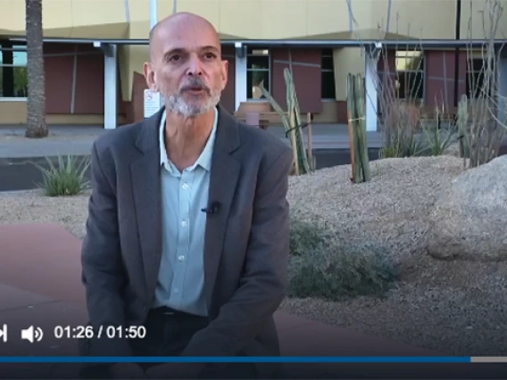 Emmanuel Katsanis is interviewed outside of the cancer center building.