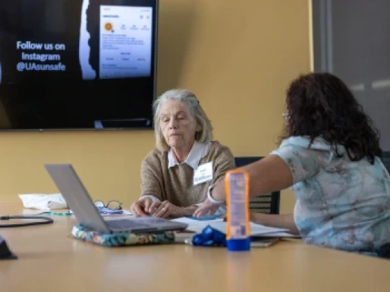 Robin Harris teaches a skin cancer institute ambassador.