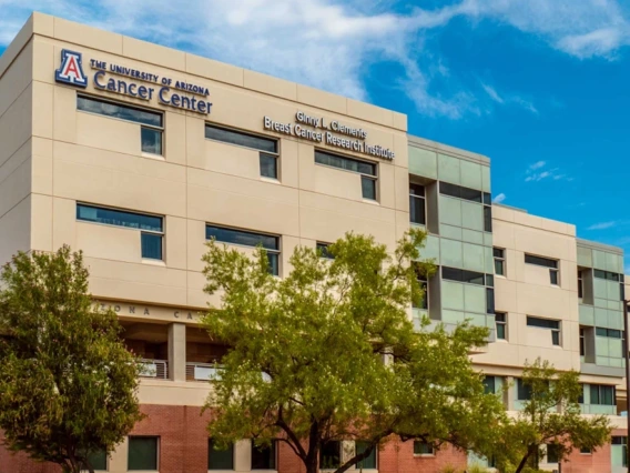 The front of the University of Arizona Cancer Center building that features the sign for the Ginny L. Clements Cancer Research Institute sign.