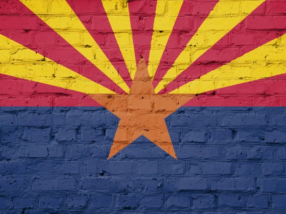 Arizona flag painted on a brick wall.