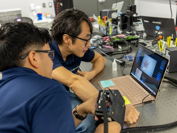 DK Kang in his laboratory working with a graduate student