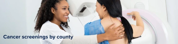 two people, one getting a breast cancer screening