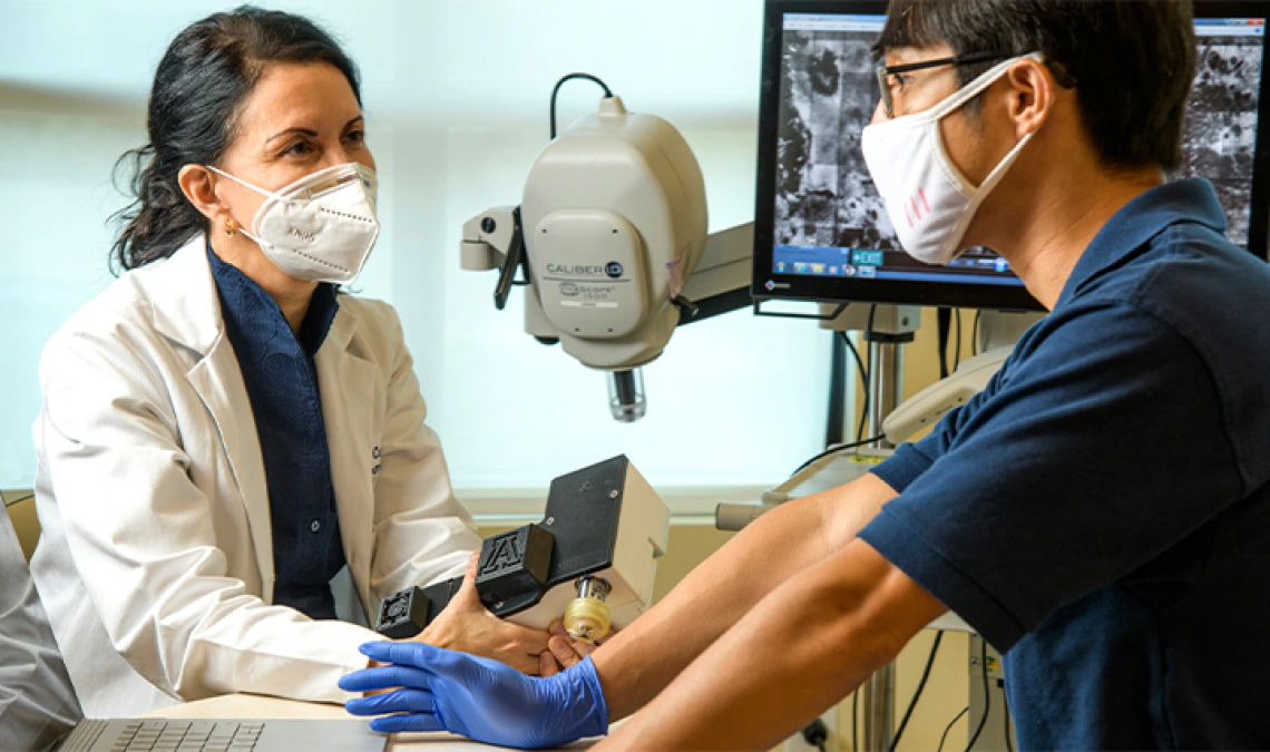 Clara Curiel-Lewandrowski, MD, and Dongkyun Kang, PhD, are collaborating to create a portable, less expensive version of a skin cancer diagnostic microscope.