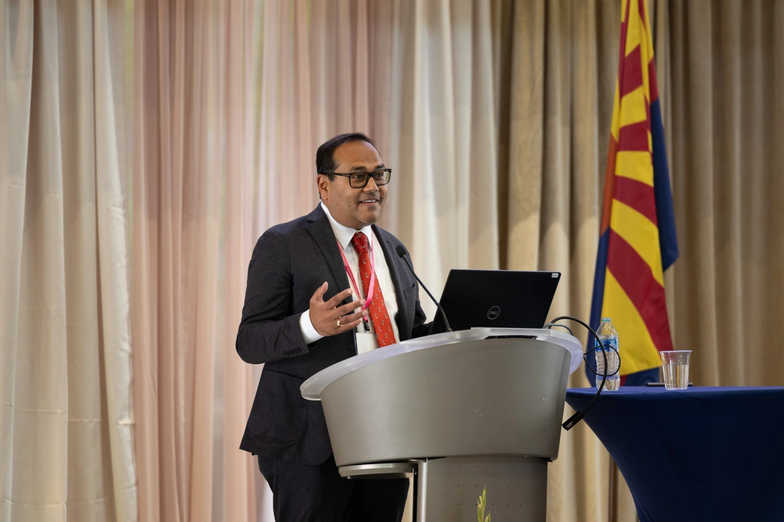 A doctor speaks at the podium during the symposium.