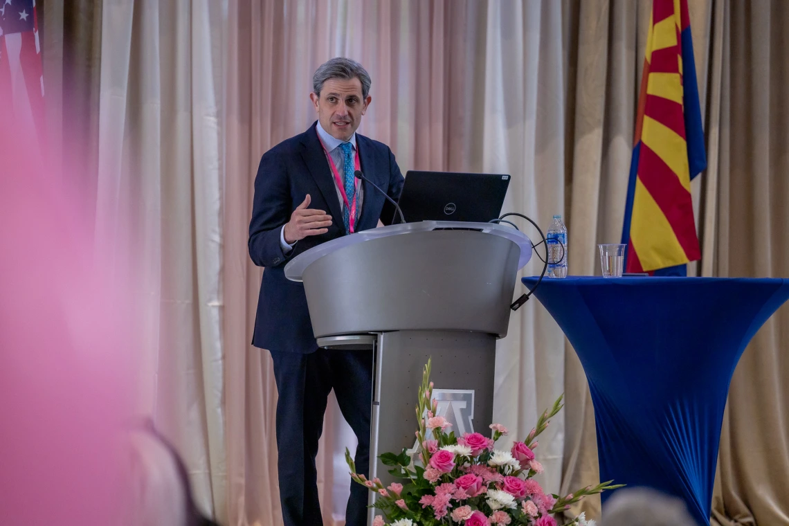 Dr. Kevin Kalinsky speaks at the podium during the symposium.