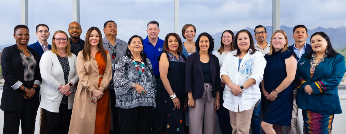 The Community Advisory Board takes a photo in a board room at the University of Arizona Cancer Center.