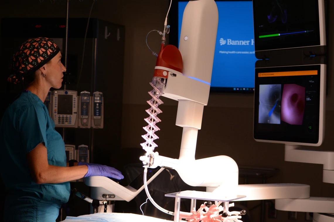 Surgeon Stephanie Worrell operates a robotic machine in a surgery room of Banner Health and the University of Arizona