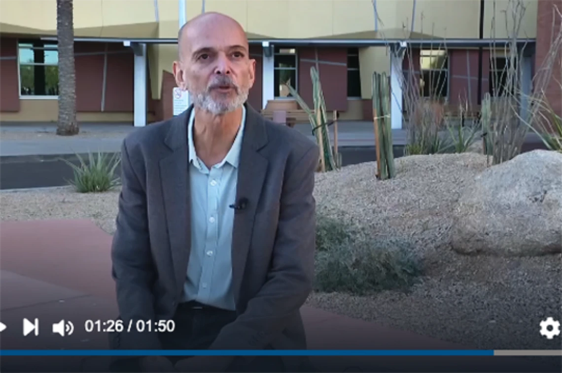 Emmanuel Katsanis is interviewed outside of the cancer center building.