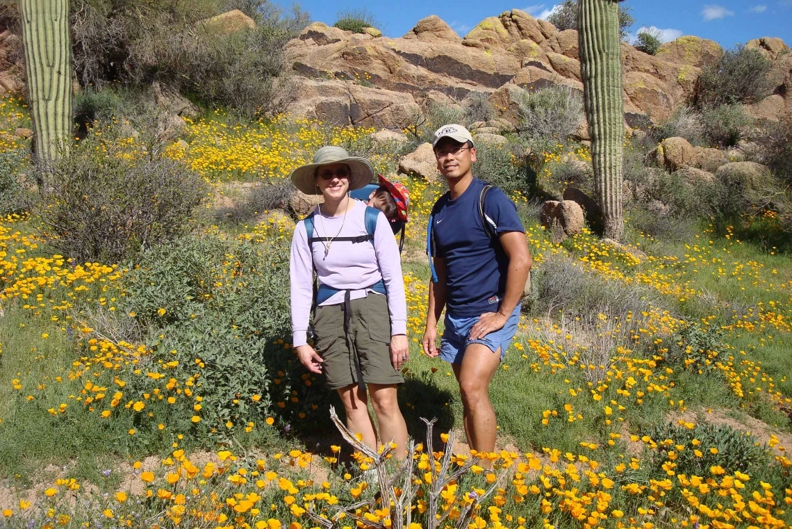 Karen Hastings and her husband walk along a mountain trail on a sunny day in Tucson.