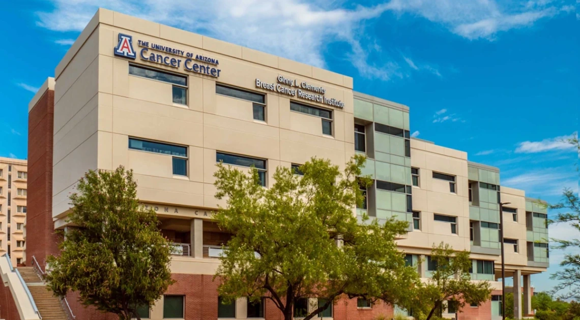 The front of the University of Arizona Cancer Center building that features the sign for the Ginny L. Clements Cancer Research Institute sign.