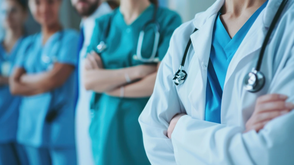 healthcare workers with their arms crossed.