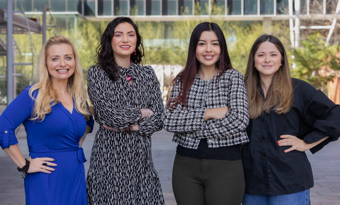 Melissa Herbst-Kralovetz and three students smile for a photo outside of the BIO5 building at the University of Arizona.