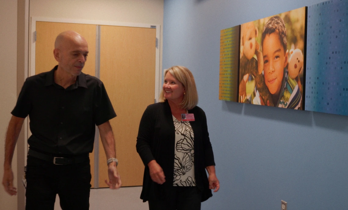 Emmanuel Katsanis, MD, walks through a hallway with a colleague at the Banner Health Diamond Children’s cancer center.