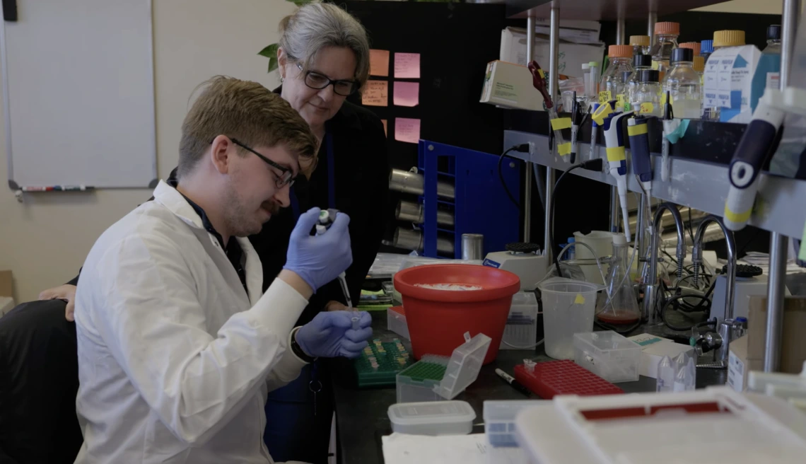 Joyce Schroeder working with laboratory technician