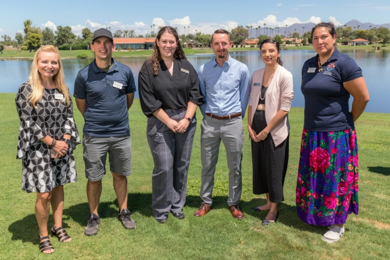 NACP Research Projects group of six people stand for a photo on a sunny day.