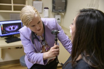 Dr. Julie Bauman examining a patient.