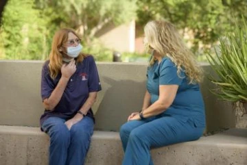 Jones’ upbeat and positive spirit endeared her to clinical support staff members including senior research nurse Sylvia Paton (right). Jones continues to receive the experimental drug, ficlatuzumab, that was studied in the clinical trial.