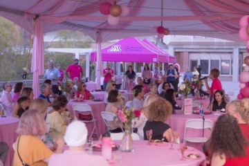 Event attendees listen as Ginny L. Clements tells them her experience with breast cancer.
