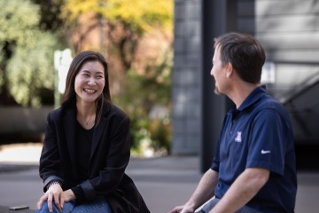 Sarah Yeo, PhD and her T32 mentor, Scott Carvajal, PhD, talk outside the University of Arizona Public Health building.