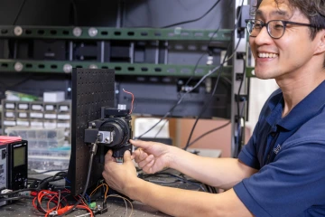 D.K. Kang, PhD, works on a portable confocal microscope in his optical lab.