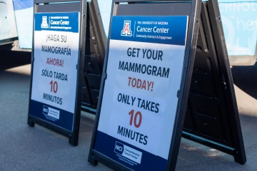 Photo of a sign in front of the mobile mammography unit that says Get your mammogram today! Only takes 10 minutes! Sign is in both English and Spanish.