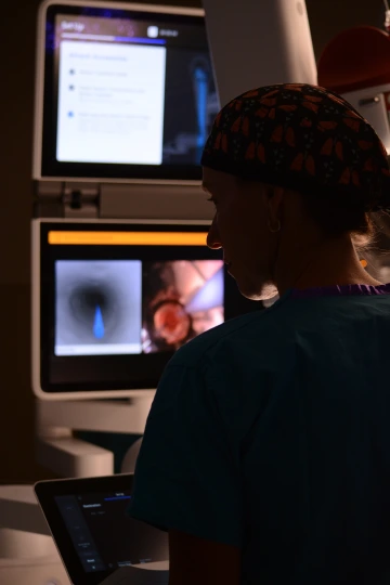 Dr. Worrell checks a monitor in a surgery room at Banner Health in Tucson.