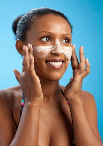 Woman applying sunscreen