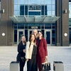 Four people stand in front of the National Cancer Institute.