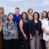 The Community Advisory Board takes a photo in a board room at the University of Arizona Cancer Center.