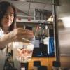 Sherry Chow, PhD, looks at a beaker inside her lab.