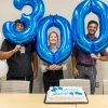 Three pulmonologists hold balloons celebrating 300 biopsies