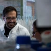 Postdoctoral researcher and cancer virologist Rob Jackson works with doctoral candidate Isabelle (Issy) Tobey