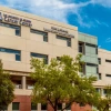 The front of the University of Arizona Cancer Center building that features the sign for the Ginny L. Clements Cancer Research Institute sign.