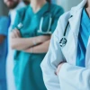 healthcare workers with their arms crossed.