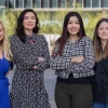 Melissa Herbst-Kralovetz and three students smile for a photo outside of the BIO5 building at the University of Arizona. 