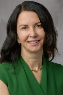 Dr. Curiel poses for a headshot wearing a green buttondown shirt.