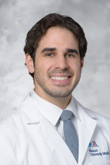Jack Hannallah, MD, smiles in a portrait in a white lab coat.