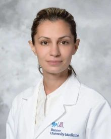 Dr. Luisine Mesropyan wears a white lab coat.