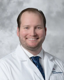 Photo of Lucas Struycken wearing a lab coat and tie.