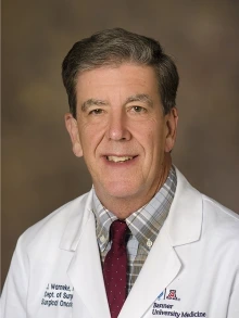 Portrait of James Warneke in a lab coat.