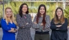 Four University of Arizona researchers from the HPV, dysplasia and cervical cancer study stop for a photo outside a building on campus.