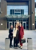 Four people stand in front of the National Cancer Institute.