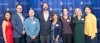 Eight Cancer Center award winners take a photo in front of a backdrop at an awards dinner.